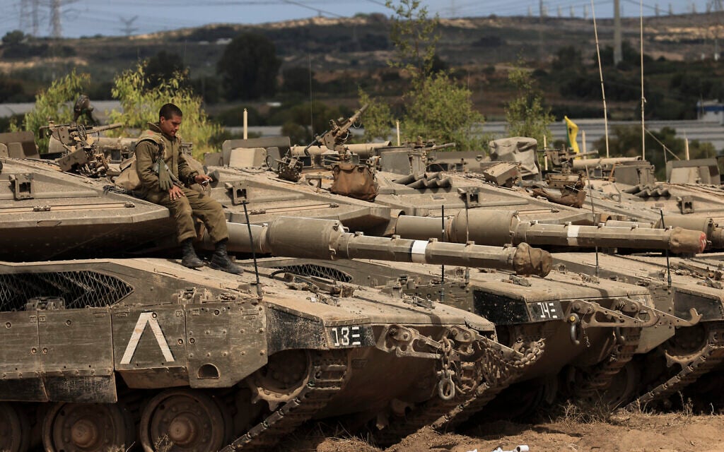 An Israeli soldier sits on top of a tank at a staging ground near the border with Gaza Strip, southern Israel, May 21, 2021. (AP Photo/Tsafrir Abayov)