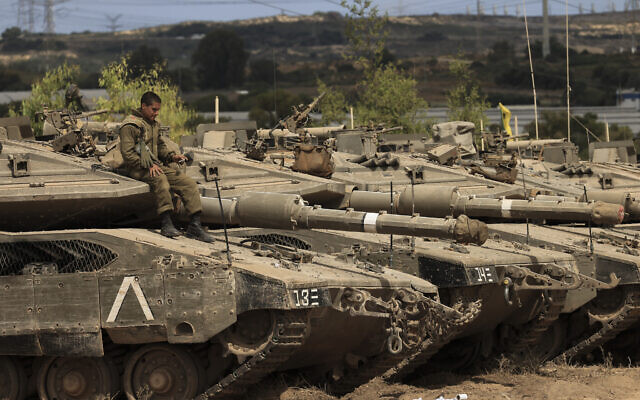 An Israeli soldier sits on top of a tank at a staging ground near the border with Gaza Strip, southern Israel, May 21, 2021. (AP Photo/Tsafrir Abayov) An Israeli soldier sits on top of a tank at a staging ground near the border with Gaza Strip, southern Israel, May 21, 2021. (AP Photo/Tsafrir Abayov)