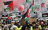 Protesters hold placards and banners in London, May 22, 2021, as they take part in a rally supporting Palestinians. (AP Photo/Alastair Grant)