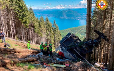 Rescuers work by the wreckage of a cable car after it collapsed near the summit of the Stresa-Mottarone line in the Piedmont region, northern Italy, May 23, 2022. (Soccorso Alpino e Speleologico Piemontese via AP)