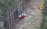 Rescuers work by the wreckage of a cable car after it collapsed near the summit of the Stresa-Mottarone line in the Piedmont region, northern Italy, as seen from the aerial photograph, May 23, 2021. (Vigili del Fuoco Firefighters via AP)