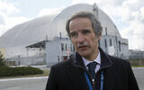 In this April 27, 2021 photo, Director-General of the International Atomic Energy Agency, Rafael Mariano Grossi in front of a shelter construction which covers the exploded reactor at the Chernobyl nuclear plant, in Chernobyl, Ukraine. (AP Photo/Efrem Lukatsky)