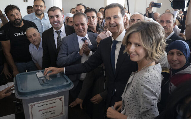 Syrian President Bashar Assad and his wife Asma vote at a polling station during the presidential elections in the town of Douma, in the eastern Ghouta region, near the Syrian capital Damascus, May 26, 2021. (AP Photo/Hassan Ammar) Syrian President Bashar Assad and his wife Asma vote at a polling station during the presidential elections in the town of Douma, in the eastern Ghouta region, near the Syrian capital Damascus, May 26, 2021. (AP Photo/Hassan Ammar)