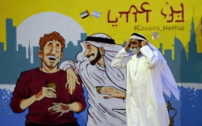 Ahmed Al Mansoori, founder of Crossroads of Civilization private museum, passes by a painting presenting UAE and Israel friendship at an exhibition commemorating the Jewish Holocaust, in Dubai, United Arab Emirates, May 26, 2021. (Kamran Jebreili/AP)