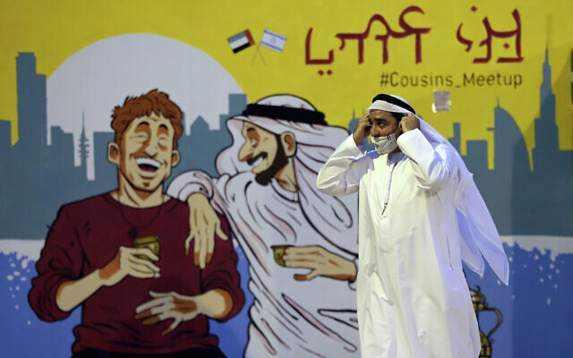 Ahmed Al Mansoori, founder of Crossroads of Civilization private museum, passes by a painting presenting UAE and Israel friendship at an exhibition commemorating the Jewish Holocaust, in Dubai, United Arab Emirates, May 26, 2021. (Kamran Jebreili/AP)