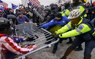 In this file photo from Jan. 6, 2021, Trump supporters beset a police barrier at the Capitol in Washington. (AP Photo/John Minchillo, File)
