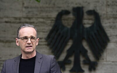 German Foreign Minister Heiko Maas addresses the media during a statement at the Foreign Ministry in Berlin, Germany, Friday, May 28, 2021. Germany has reached an agreement with Namibia that will see it officially recognize as genocide the colonial-era killings of tens of thousands of people and commit to spending a total of 1.1 billion euros ($1.3 billion), largely on development projects. (Tobias Schwarz/Pool Photo via AP)