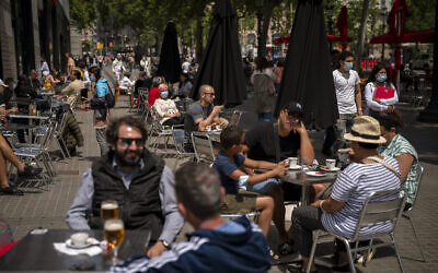 Customers sit in a terrace bar in downtown Barcelona, Spain, May 28, 2021. (AP Photo/Emilio Morenatti, File)