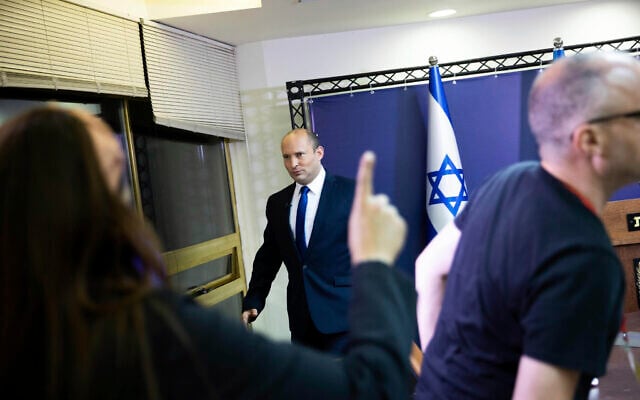 Yamina party leader Naftali Bennett arrives to speak from the Knesset on May 30, 2021, in an address at which he said he was working to firm a unity government with Yesh Atid's Yair Lapid. (Yonatan Sindel/Pool via AP) Yamina party leader Naftali Bennett arrives to speak from the Knesset on May 30, 2021, in an address at which he said he was working to firm a unity government with Yesh Atid's Yair Lapid. (Yonatan Sindel/Pool via AP)