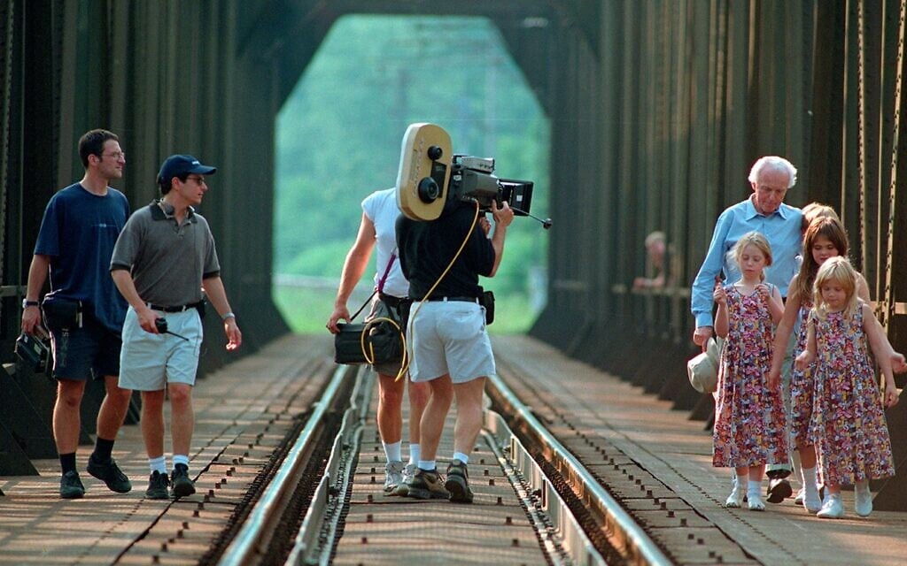 Tom Lantos and his grandchildren visit a bridge north of Budapest where he performed forced labor during the shooting of the 1998 documentary 'The Last Days.' (Courtesy)