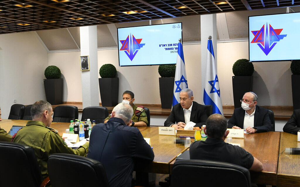 Prime Minister Benjamin Netanyahu, center, facing camera, and other top officials holding security consultations at defense headquarters in Tel Aviv on May 10, 2021. (Amos Ben Gershom/GPO)