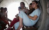 Illustrative image: Children sit together inside a street shelter, in anticipation of the Code Red siren alerting of incoming rockets, in the Southern Israeli town of Nitzan, on the fourth day of Operation Protective Edge, July 11, 2014. (Flash 90)