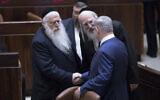 Prime Minister Benjamin Netanyahu, right, shakes hands with United Torah Judaism MKs Yisrael Eichler, center and Meir Porush in the Knesset, January 25, 2019. (Yonatan Sindel/Flash90/File)