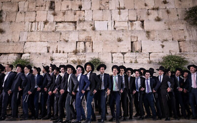 Ultra-Orthodox Jewish men dance at the end of the Jewish holiday of Shavuot, at the Western Wall, in the Old City of Jerusalem on June 9, 2019. (Aharon Krohn/Flash90)