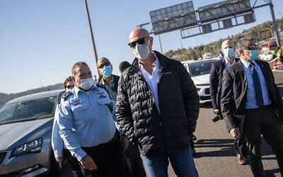 Minister of Public Security Amir Ohana and acting Police Chief Kobi Shabtai visit a temporary roadblock on Route 1 outside Jerusalem on January 8, 2021. (Yonatan Sindel/Flash90)