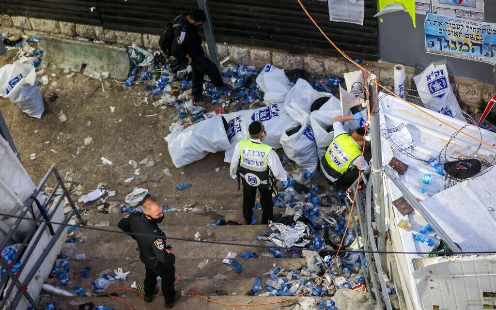 Israeli rescue forces and police stand on the stairs where a mass of people were crushed to death and injured during the celebrations of the Lag B'Omer holiday on Mount Meron, in northern Israel on April 30, 2021. (David Cohen/Flash90) Israeli rescue forces and police stand on the stairs where a mass of people were crushed to death and injured during the celebrations of the Lag B'Omer holiday on Mount Meron, in northern Israel on April 30, 2021. (David Cohen/Flash90)