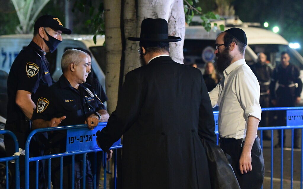 Relatives of those killed in the Mount Meron disaster are seen outside the Institute of Forensic Medicine in Tel Aviv, where the bodies of the 45 victims were taken for identification, May 1, 2021. (Avshalom Sassoni/Flash90)