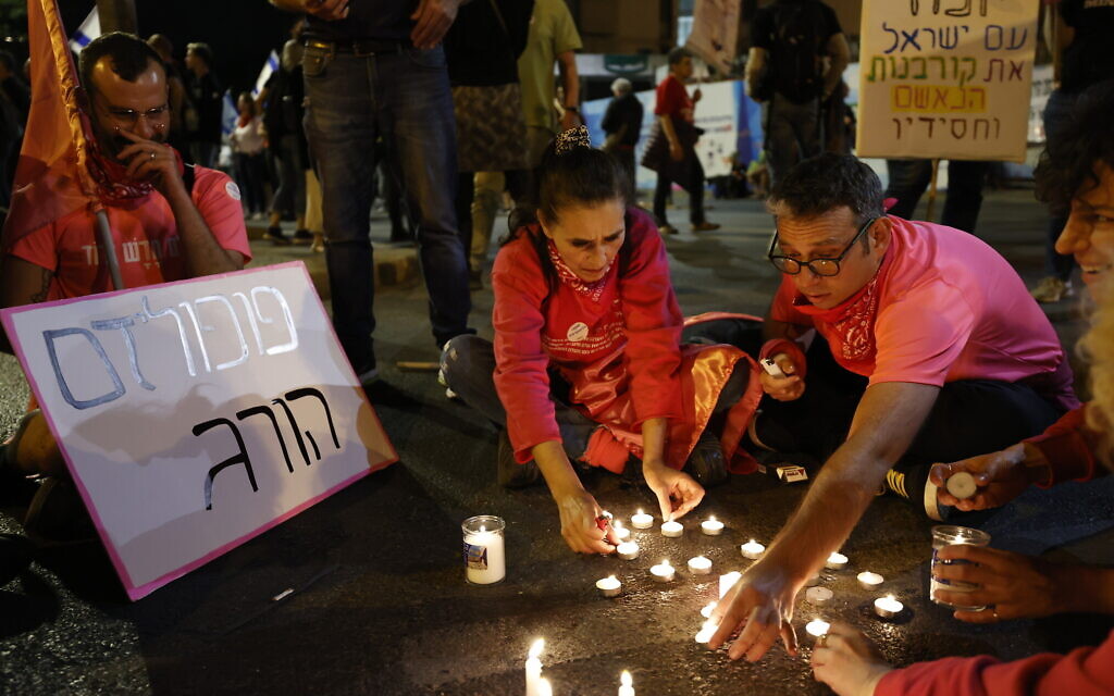 Anti-Netanyahu protesters light candles for the 45 victims who were killed in the deadly crushing at Mount Meron during Lag B'Omer celebrations, at the weekly protest outside the Prime Minister's Residence in Jerusalem, May 1, 2021. (Yonatan Sindel/Flash90)