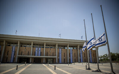 Israeli flags lowered to half-staff in honor of Mount Meron crush victims, at the Knesset in Jerusalem, May 2, 2021. (Yonatan Sindel/Flash90)