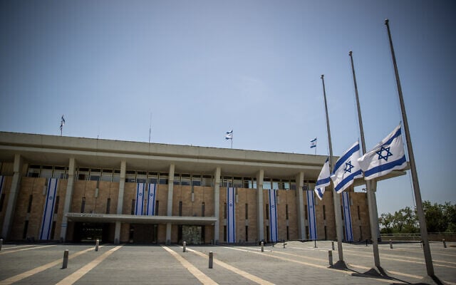 Israeli flags lowered to half-staff in honor of Mount Meron crush victims, at the Knesset in Jerusalem, May 2, 2021. (Yonatan Sindel/Flash90) Israeli flags lowered to half-staff in honor of Mount Meron crush victims, at the Knesset in Jerusalem, May 2, 2021. (Yonatan Sindel/Flash90)