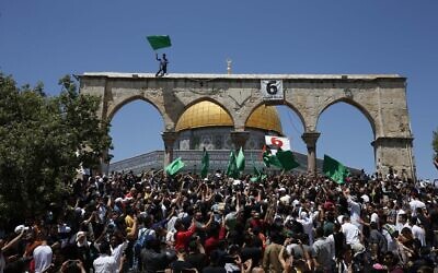 People hold Hamas flags as Palestinians gather at the Dome of the Rock after praying on the last Friday of Ramadan, May 7, 2021. (Jamal Awad/Flash90)