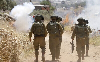 Israeli soldiers clash with Palestinians during a protest in the village of Beit Dajan, near the West Bank city of Nablus on May 7, 2021 (Nasser Ishtayeh/Flash90)