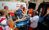 Palestinians evacuate a wounded protester during clashes with Israeli security forces in Jerusalem's Old City on Jerusalem Day, May 10, 2021. Photo by Olivier Fitoussi/Flash90