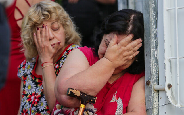 Women react at the scene where an apartment building was hit by a rocket fired from the Gaza Strip in Ashkelon, southern Israel, on May 11, 2021. (Edi Israel/Flash90) Women react at the scene where an apartment building was hit by a rocket fired from the Gaza Strip in Ashkelon, southern Israel, on May 11, 2021. (Edi Israel/Flash90)