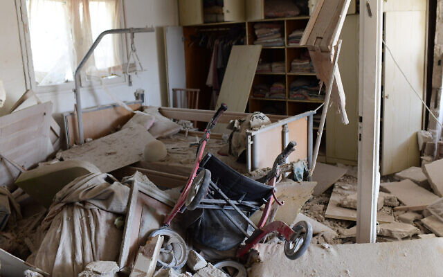 The scene where a rocket fired from the Gaza Strip hit a house in the southern Israeli city of Ashkelon on May 11, 2021. (Tomer Neuberg/Flash90) The scene where a rocket fired from the Gaza Strip hit a house in the southern Israeli city of Ashkelon on May 11, 2021. (Tomer Neuberg/Flash90)