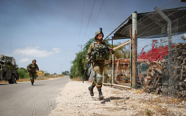 Israeli soldiers near the site of where a jeep was hit by an anti-tank missile fired from Gaza, May 12, 2021 (Yonatan Sindel/Flash90) Israeli soldiers near the site of where a jeep was hit by an anti-tank missile fired from Gaza, May 12, 2021 (Yonatan Sindel/Flash90)