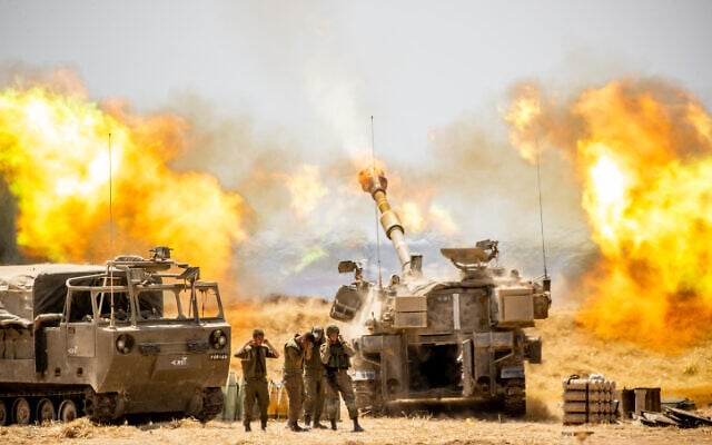 IDF artillery seen firing into Gaza near the Israeli border with the Strip on May 12, 2021, following heavy rocket and missile barrage fired into Israel, May 12, 2021 (Yonatan Sindel/Flash90) IDF artillery seen firing into Gaza near the Israeli border with the Strip on May 12, 2021, following heavy rocket and missile barrage fired into Israel, May 12, 2021 (Yonatan Sindel/Flash90)
