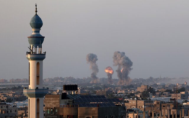 Smoke and flames rise after an Israeli airstrike in the southern Gaza Strip, May 12, 2021. (Abed Rahim Khatib/Flash90) Smoke and flames rise after an Israeli airstrike in the southern Gaza Strip, May 12, 2021. (Abed Rahim Khatib/Flash90)