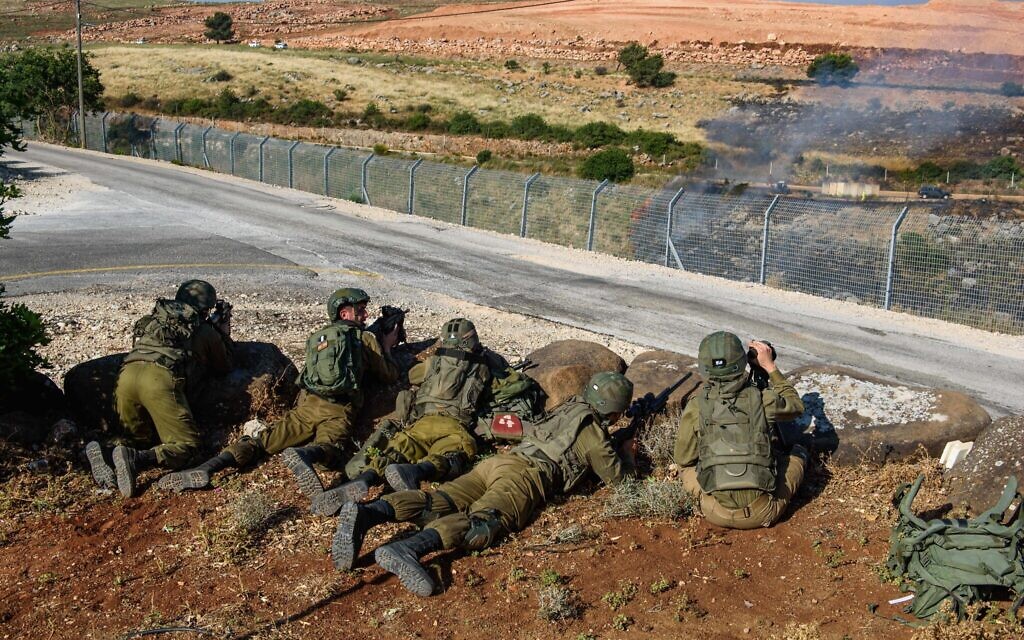 Ilustrative: Israeli soldiers guard in Metula, on the border between Israel and Lebanon, northern Israel, on May 14, 2021, after Lebanese protesters crossed the Israeli border fence. (Basel Awidat/Flash90)