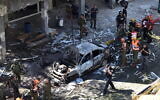 Police and rescue personnel at the scene of a rocket strike in Ramat Gan that killed Gershon Franco, 50, on May 15, 2021 (Gili Yaari /Flash90)
