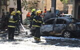 Rescue workers on the scene where a rocket hit fired from the Gaza Strip hit Ramat Gan, killing one, May 15, 2021 (Gili Yaari /Flash90)