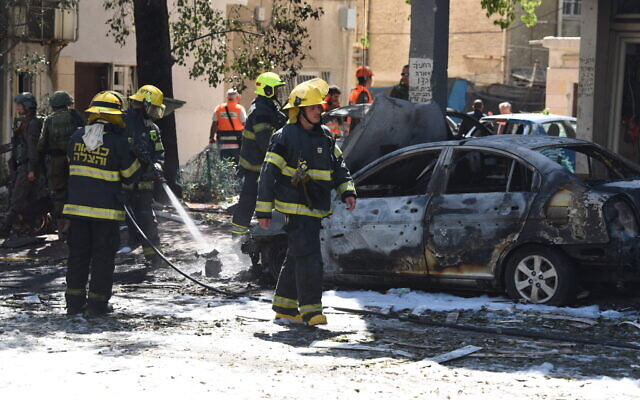 Rescue workers on the scene where a rocket hit fired from the Gaza Strip hit Ramat Gan, killing one, May 15, 2021 (Gili Yaari /Flash90) Rescue workers on the scene where a rocket hit fired from the Gaza Strip hit Ramat Gan, killing one, May 15, 2021 (Gili Yaari /Flash90)