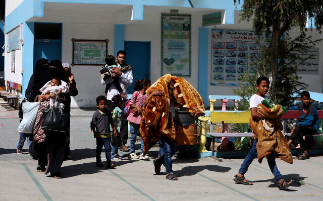 Palestinian families whose homes were damaged by Israeli aircraft strikes in response to rocket fire are displaced to a United Nations school in Rafah, southern Gaza Strip, on May 17, 2021 (Abed Rahim Khatib/Flash90) Palestinian families whose homes were damaged by Israeli aircraft strikes in response to rocket fire are displaced to a United Nations school in Rafah, southern Gaza Strip, on May 17, 2021 (Abed Rahim Khatib/Flash90)