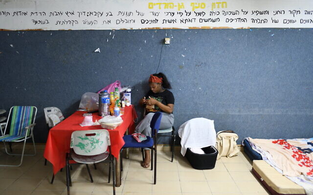 Shahar Beine, 22, with her newborn 7 days old daughter (in the cradle) sits inside a public bomb shelter, during a rocket barrage fired from the Gaza strip at the Southern city of Ashkelon, on May 18, 2021. (Gili Yaari /Flash90) Shahar Beine, 22, with her newborn 7 days old daughter (in the cradle) sits inside a public bomb shelter, during a rocket barrage fired from the Gaza strip at the Southern city of Ashkelon, on May 18, 2021. (Gili Yaari /Flash90)