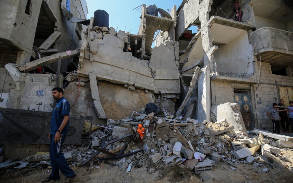 Palestinians inspect the damage following an Israeli air strike in Rafah in the southern Gaza Strip, on May 19, 2021 (Abed Rahim Khatib/Flash90)