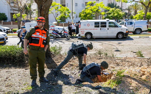 Israeli security forces at the scene where part of a rocket fired from the Gaza Strip landed in the southern port city of Ashdod, May 19, 2021. (Flash90) Israeli security forces at the scene where part of a rocket fired from the Gaza Strip landed in the southern port city of Ashdod, May 19, 2021. (Flash90)