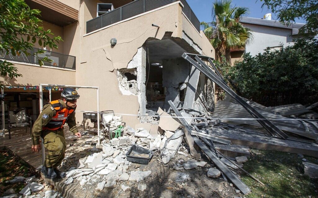 A soldier from the Israeli military's Home Front Command walks outside a house in the southern Israeli city of Ashkelon that had been struck by a Hamas rocket on May 20, 2021. (Edi Israel/FLASH90) A soldier from the Israeli military's Home Front Command walks outside a house in the southern Israeli city of Ashkelon that had been struck by a Hamas rocket on May 20, 2021. (Edi Israel/FLASH90)