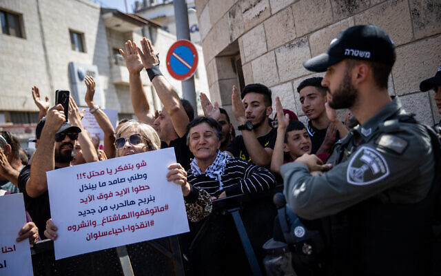 Palestinians protest outside the District Court in Jerusalem against Israel's plan to evict Palestinians in the East Jerusalem neighborhood of Silwan, on May 26, 2021. (Yonatan Sindel/Flash90) Palestinians protest outside the District Court in Jerusalem against Israel's plan to evict Palestinians in the East Jerusalem neighborhood of Silwan, on May 26, 2021. (Yonatan Sindel/Flash90)