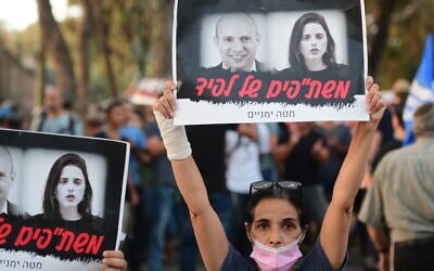 Right-wing protestors outside the home of Yamina MK Ayelet Shaked  in Tel Aviv on May 30, 2021. The sign with a picture of Shaked and Yamina leader Naftali Bennett reads 'Lapid's collaborators'  (Avshalom Sassoni/Flash90)