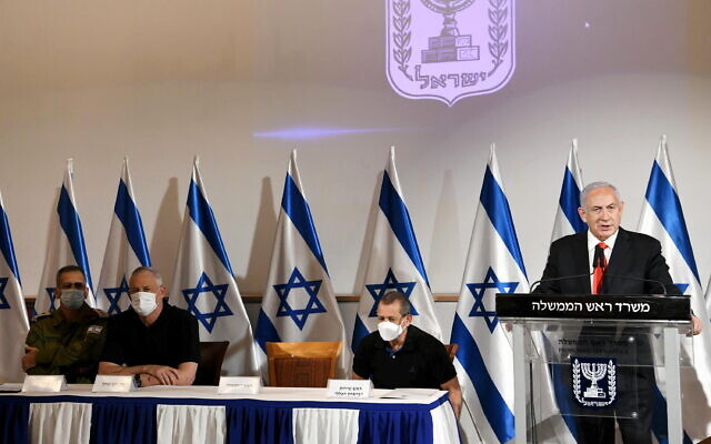 Prime Minister Benjamin Netanyahu addresses Israel after unprecedented Hamas rocket fire on central Israel, May 11, 2021. Also present, from left: IDF chief of staff Aviv Kohavi; Defense Minister Benny Gantz and Shin Bet chief Nadav Argaman (Amos Ben-Gershom / GPO) Prime Minister Benjamin Netanyahu addresses Israel after unprecedented Hamas rocket fire on central Israel, May 11, 2021. Also present, from left: IDF chief of staff Aviv Kohavi; Defense Minister Benny Gantz and Shin Bet chief Nadav Argaman (Amos Ben-Gershom / GPO)