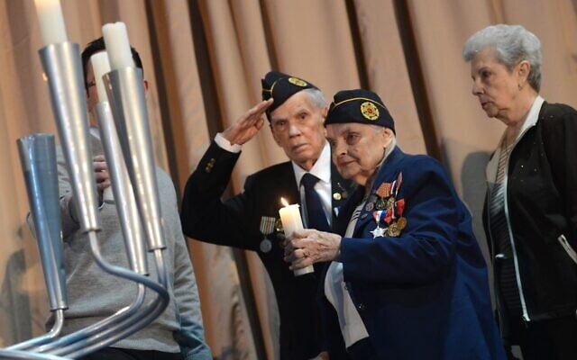 Faye Schulman lights a candle at a ceremony commemorating the 70th anniversary of the Warsaw Ghetto Uprising at a UJA Federation building in Toronto in 2013. (Vince Talotta/Toronto Star via Getty Images via JTA)