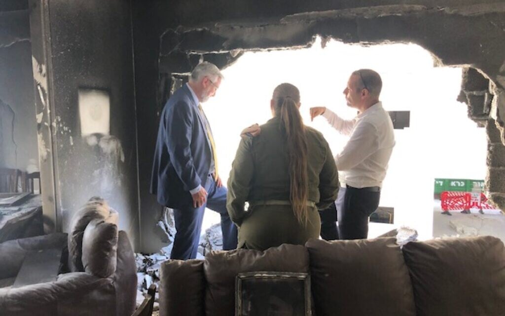 Indiana Gov. Eric Holcomb (left) surveys the wreckage of a Petah Tikva apartment hit by Hamas rocket fire, May 21, 2021. (Lazar Berman/Times of Israel) Indiana Gov. Eric Holcomb (left) surveys the wreckage of a Petah Tikva apartment hit by Hamas rocket fire, May 21, 2021. (Lazar Berman/Times of Israel)