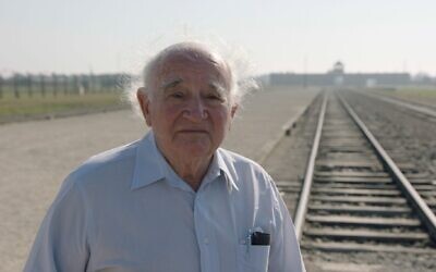 Roman Kent stands outside Auschwitz. (Courtesy of Jewish Foundation for the Righteous via JTA)