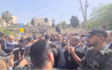 Religious Zionism MKs are guarded by police as they arrive at the Sheikh Jarrah neighborhood on May 10, 2021. (Screen capture/Twitter)