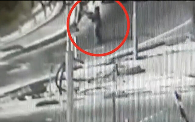 In security video released by the Israel Defense Forces, a Palestinian woman can be seen firing toward the entrance to the West Bank settlement of Kiryat Arba on May 19, 2021. (Screen capture) In security video released by the Israel Defense Forces, a Palestinian woman can be seen firing toward the entrance to the West Bank settlement of Kiryat Arba on May 19, 2021. (Screen capture)