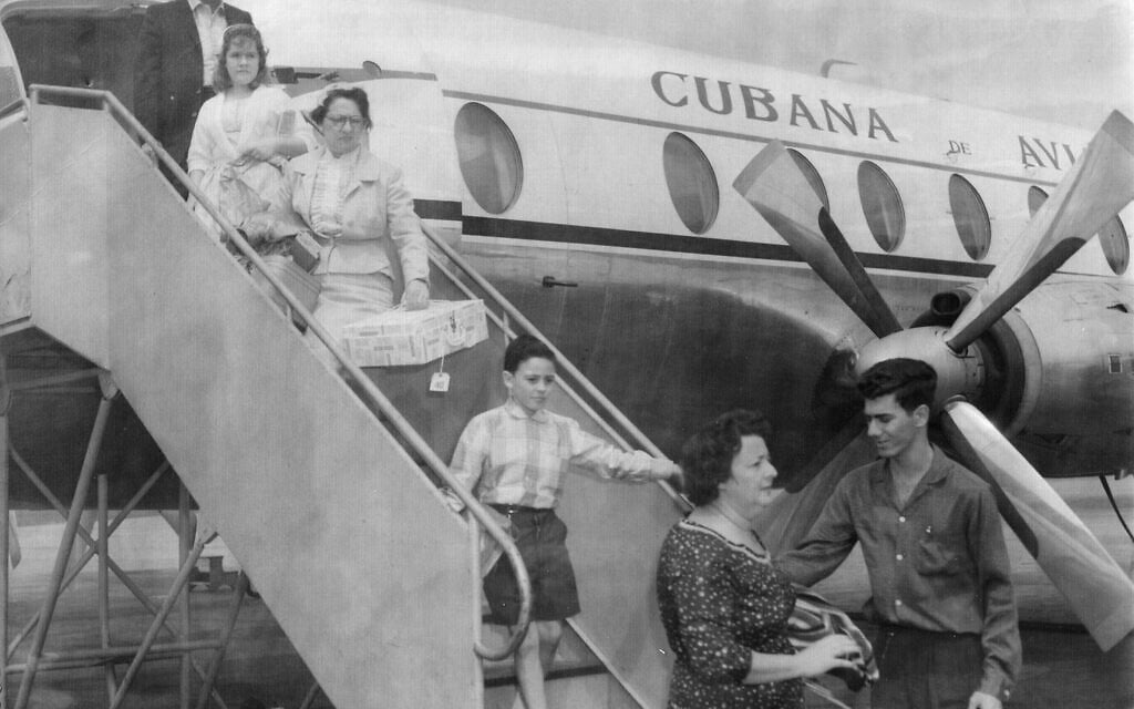 Illustrative: Ruth Behar's grandmother (carrying box) emigrating from Cuba to the US in 1961. (Courtesy)